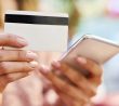 Ženské ruce drží mobil a platební kartu