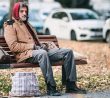 Bezdomovec na lavičce v parku